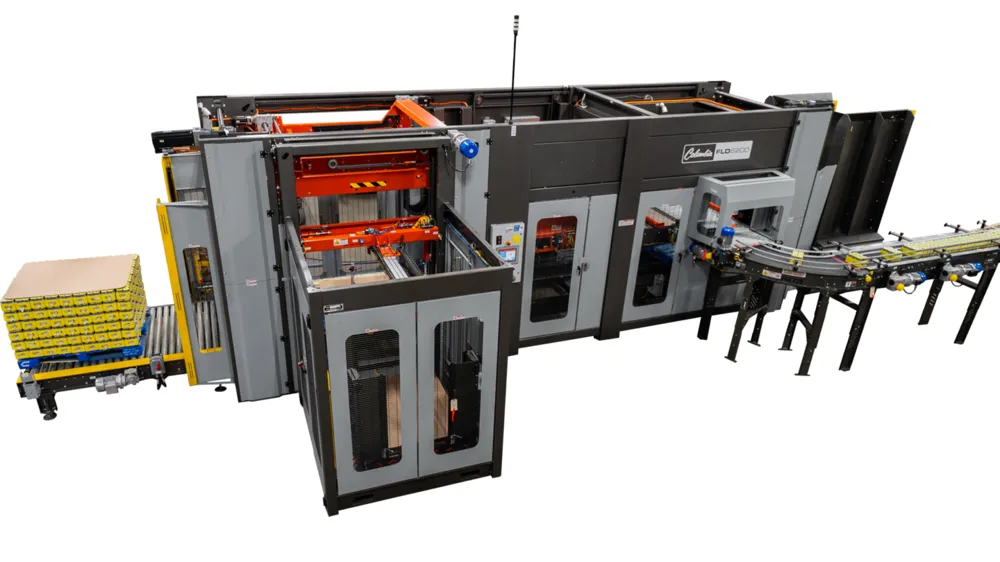 A Columbia FLD6200-SW floor level conventional palletizer with guarding and a layer hoist.