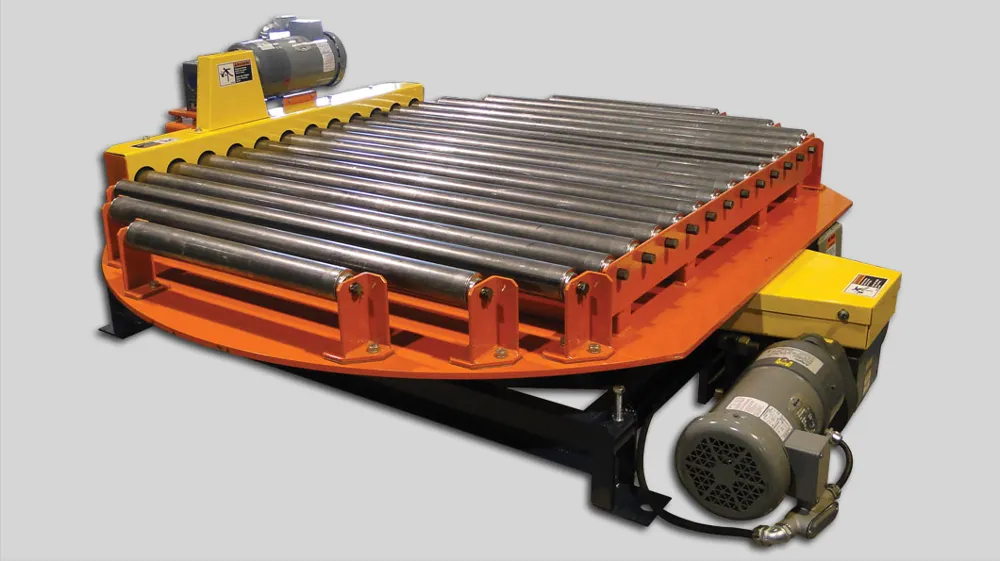 A powered turntable with a chain-driven roller conveyor section mounted on a rotating orange base.